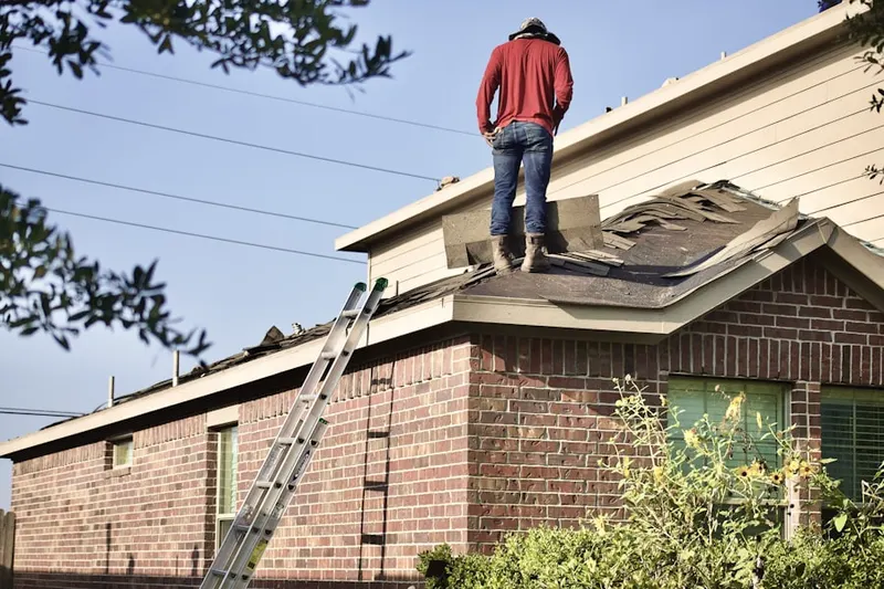 Professional roofer working on a residential roof in Surrey Woods